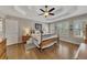 Main bedroom with hardwood floors, plantation shutters, and ceiling fan at 409 E Point Dr, Canton, GA 30115