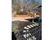 Landscaped backyard with a patio, retaining wall, and steps leading to a deck at 790 Hiram Davis Rd, Lawrenceville, GA 30045