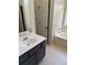 Clean bathroom with dark vanity and bathtub at 790 Hiram Davis Rd, Lawrenceville, GA 30045