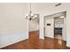 Dining room with hardwood floors, wainscoting and decorative chandelier at 33 Parklin Dr, Hiram, GA 30141