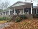 Brick ranch house with covered porch and steps, surrounded by autumn leaves at 5710 Stewart Mill Rd, Douglasville, GA 30135