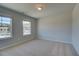 Spacious bedroom with two windows and carpet at 245 Chiswick Loop, Stockbridge, GA 30281