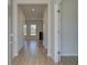 Light-filled entry hall with wood-look floors leading to the living room at 245 Chiswick Loop, Stockbridge, GA 30281