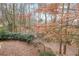 A naturally landscaped backyard with trees and bushes adding to a private and beautiful setting at 5323 Lakesprings Dr, Dunwoody, GA 30338