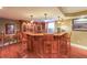 A finished basement features a custom built-in bar with seating and shelving at 5323 Lakesprings Dr, Dunwoody, GA 30338