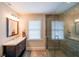 Bathroom with a glass-enclosed shower, granite countertop, and modern fixtures at 5323 Lakesprings Dr, Dunwoody, GA 30338