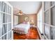 Cozy bedroom with natural light, wood flooring, and neutral walls, creating a warm and inviting atmosphere at 5323 Lakesprings Dr, Dunwoody, GA 30338