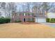 Two-story brick home with a large front yard and a two-car garage at 5323 Lakesprings Dr, Dunwoody, GA 30338