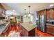 Modern kitchen featuring a granite island, stainless steel appliances, and hardwood floors at 5323 Lakesprings Dr, Dunwoody, GA 30338