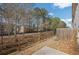 Private backyard with wooden fence and trees at 7744 Fawn Cir, Covington, GA 30014