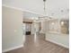 Open dining room with chandelier and hardwood floors at 7744 Fawn Cir, Covington, GA 30014