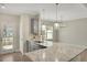 Modern kitchen with gray cabinets, granite counters, and stainless steel appliances at 7744 Fawn Cir, Covington, GA 30014