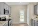 Modern kitchen with gray cabinets, granite countertops, and stainless steel appliances at 7744 Fawn Cir, Covington, GA 30014