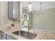 Kitchen sink featuring granite countertops and stainless steel fixtures at 7744 Fawn Cir, Covington, GA 30014