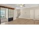 Spacious living room featuring modern sliding barn doors and durable, wood-look flooring at 7744 Fawn Cir, Covington, GA 30014