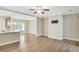 Spacious living room with hardwood floors, a ceiling fan, and a view into the kitchen at 7744 Fawn Cir, Covington, GA 30014