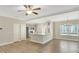 Open-concept living room featuring modern appliances and a view into the kitchen and dining area at 7744 Fawn Cir, Covington, GA 30014