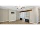 Large living room featuring hardwood floors, a ceiling fan, and barn doors to another room at 7744 Fawn Cir, Covington, GA 30014