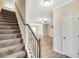 Carpeted staircase leading to the second floor with a stained wood railing at 7744 Fawn Cir, Covington, GA 30014