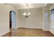 Formal dining room with hardwood floors, wainscoting, and chandelier at 876 Nevis Way, Mcdonough, GA 30253