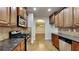 Open kitchen with stainless steel appliances and hardwood floors at 876 Nevis Way, Mcdonough, GA 30253