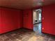 Finished basement room with red walls and slate floor at 234 Lake Ruby Dr, Suwanee, GA 30024
