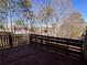 Deck overlooking wooded area with distant home views at 234 Lake Ruby Dr, Suwanee, GA 30024