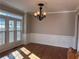 Dining room with hardwood floors, chair rail, and large windows at 234 Lake Ruby Dr, Suwanee, GA 30024