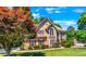 Two story house with tan siding, brown roof, and burgundy shutters at 234 Lake Ruby Dr, Suwanee, GA 30024