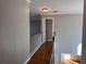 Upper hallway with hardwood floors and access to bedrooms at 234 Lake Ruby Dr, Suwanee, GA 30024