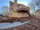 Tan two story home with deck and firepit at 234 Lake Ruby Dr, Suwanee, GA 30024