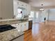 Open concept kitchen with granite countertops and hardwood floors at 234 Lake Ruby Dr, Suwanee, GA 30024