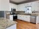 Kitchen with granite countertops, stainless steel appliances, and white cabinets at 234 Lake Ruby Dr, Suwanee, GA 30024