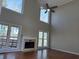 Bright living room with hardwood floors, fireplace and multiple windows at 234 Lake Ruby Dr, Suwanee, GA 30024