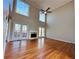 Spacious living room with hardwood floors, fireplace, and large windows at 234 Lake Ruby Dr, Suwanee, GA 30024