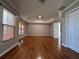 Spacious main bedroom with hardwood floors and tray ceiling at 234 Lake Ruby Dr, Suwanee, GA 30024