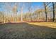 A vast backyard features manicured lawn and mature trees, ideal for outdoor activities at 2400 Stedman Sw Ln, Conyers, GA 30094