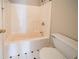 Bathroom with white tub-shower combo and toilet with black-and-white flooring at 2400 Stedman Sw Ln, Conyers, GA 30094