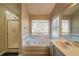 Bathroom featuring a tiled walk-in shower, soaking tub, and vanity sink at 2400 Stedman Sw Ln, Conyers, GA 30094