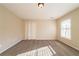 Bright bedroom features plush neutral carpet, closet and large window at 2400 Stedman Sw Ln, Conyers, GA 30094