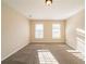 Spacious bedroom featuring neutral carpet, two windows and cream colored walls at 2400 Stedman Sw Ln, Conyers, GA 30094