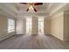 Spacious bedroom featuring neutral walls, carpeted flooring, tray ceilings, and bright light at 2400 Stedman Sw Ln, Conyers, GA 30094
