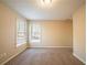 Neutral colored carpeted bedroom with two windows with blinds at 2400 Stedman Sw Ln, Conyers, GA 30094