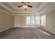 Light and airy bedroom with tray ceilings, carpeted flooring, and bright natural lighting at 2400 Stedman Sw Ln, Conyers, GA 30094