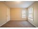 Carpeted bedroom features a window with blinds and a white closet door at 2400 Stedman Sw Ln, Conyers, GA 30094