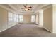 Large bedroom featuring tray ceilings, neutral walls, and carpeted flooring at 2400 Stedman Sw Ln, Conyers, GA 30094