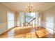 Formal dining room featuring hardwood floors, wainscoting, and staircase view at 2400 Stedman Sw Ln, Conyers, GA 30094