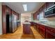 A kitchen with stainless steel appliances, wood cabinets, and hardwood floors at 2400 Stedman Sw Ln, Conyers, GA 30094