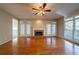 Spacious living room featuring hardwood floors, fireplace, and natural light from surrounding windows at 2400 Stedman Sw Ln, Conyers, GA 30094