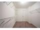 Walk-in closet featuring carpeted floors and metal shelving for optimal storage at 2400 Stedman Sw Ln, Conyers, GA 30094
